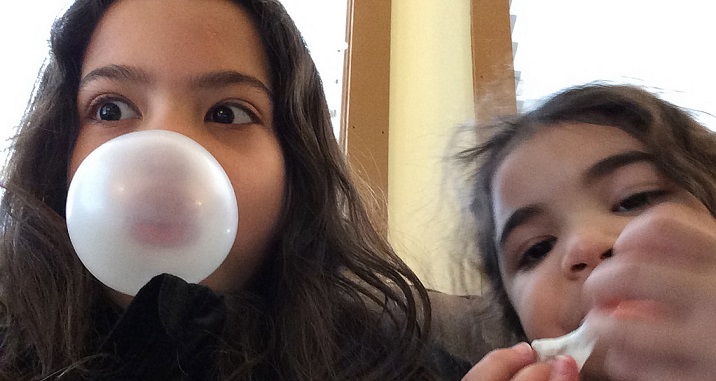Kids blowing bubble gum bubbles