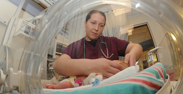 110304-N-7491B-024 SAN DIEGO (March 4, 2011) Lt. Lauren Mattingly, an intern in the Naval Medical Center San Diego Graduate Medical Education program, examines a newborn baby in the Neonatal Intensive Care Unit. The graduate program trains doctors in the development of clinical and professional skills. The hospital has 24 accredited programs such as obstetrics gynecology, internal medicine and orthopedics. More than 70 interns are enrolled in the 2011 Graduate Medical Education program. (U.S. Navy photo by Mass Communication Specialist Seaman Joseph A. Boomhower/Released)
