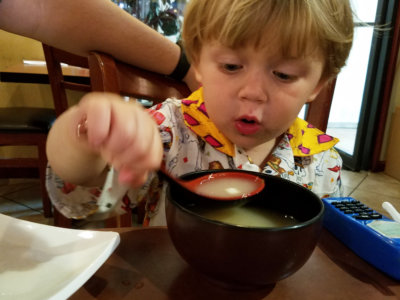 Child blowing on soup