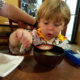 Child blowing on soup