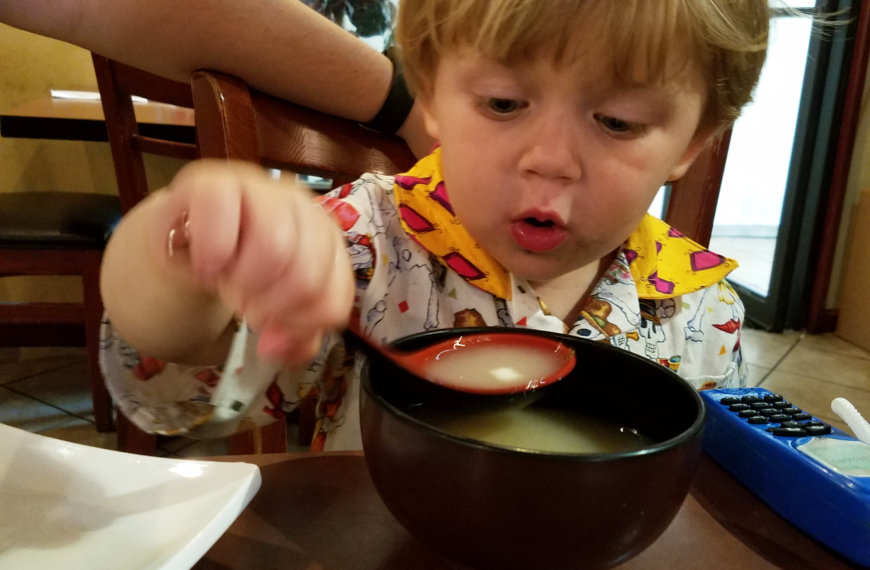 Child blowing on soup