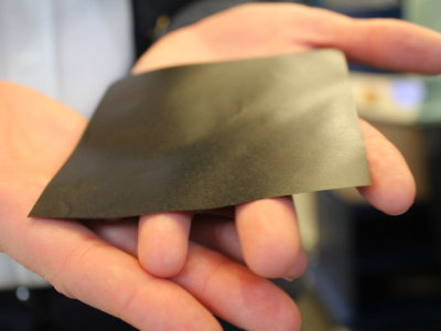 Thin gray sheet of graphene held in a hand